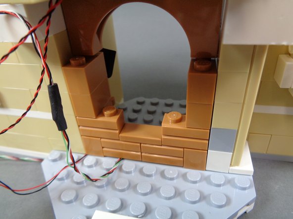 As shown in the photos for this step, continue re-assembling the stove.  By the end of this step, your stove should be completely re-assembled as shown in the third photo.