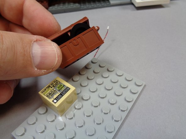 As shown in the first photo, remove the brown trunk from the attic floor.