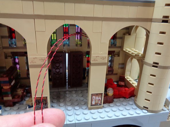 At the end of this process, you should have the two fireplace light wires running up the backside of the column and exiting at the top as shown in the third photo.