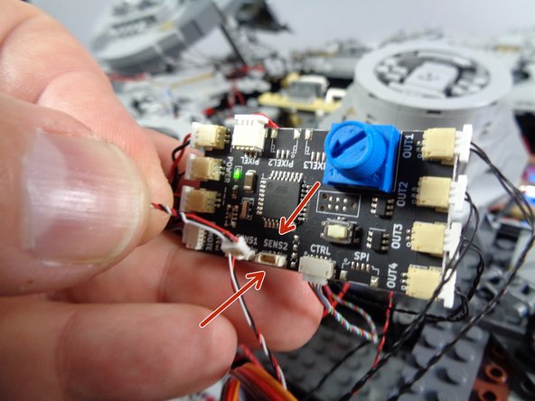 As shown in the first photo, connect the servo wire plug to the &quot;SENS2&quot; connector on your Falcon's TRUNK08 master effect controller.