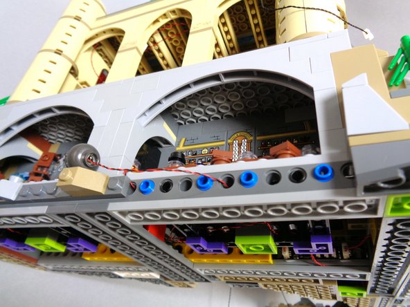 If your BRANCH09 adapter board has side-facing connectors, connect the cauldron light power wire to the last open plug on the BRANCH09 adapter as shown by the purple arrow in the second photo.  All five plugs on the BRANCH09 adapter board should now be full.