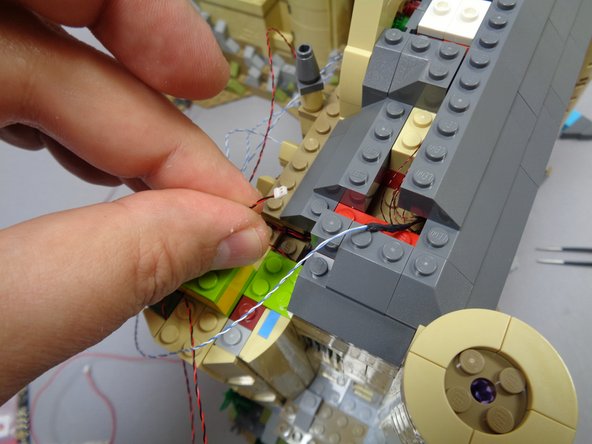 As shown in the second photo, pull the light wire through the hole in the roof behind the tower, then connect to plug #3 on the BRANCH09X adapter board as shown by the blue circle in the third photo.