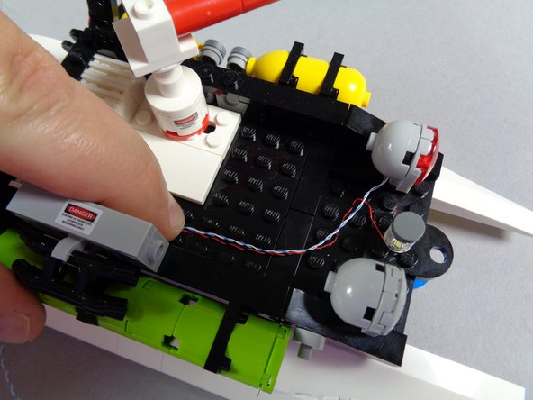 You can now carefully re-attach the white square roof assembly you removed earlier.