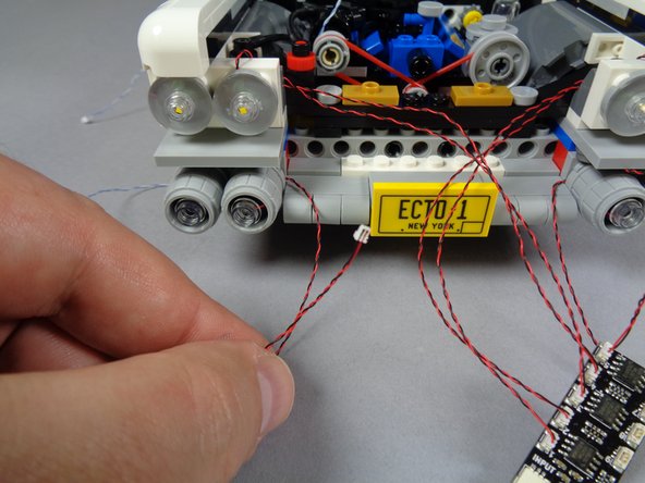Repeat the earlier steps again to mount the LED light inside the third lower headlight.