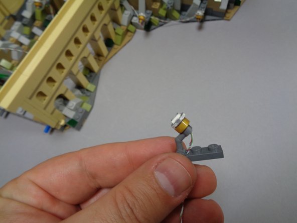 The first two photos in this step show an alternate way to mount spotlights if you need them to shine upward from within a limited space.  You can remove the gold part of the spotlight from its clip and re-attach the light facing backwards.