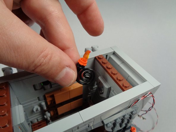 As shown in the third photo for this step, disassemble the two torches.  You will replace the black round 1x1 plates in the next step.