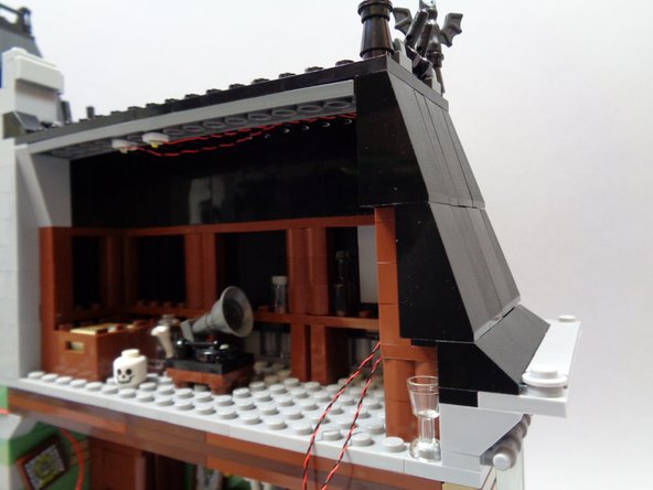 As shown in the second and third photos, re-attach the roof slope pieces you removed earlier.