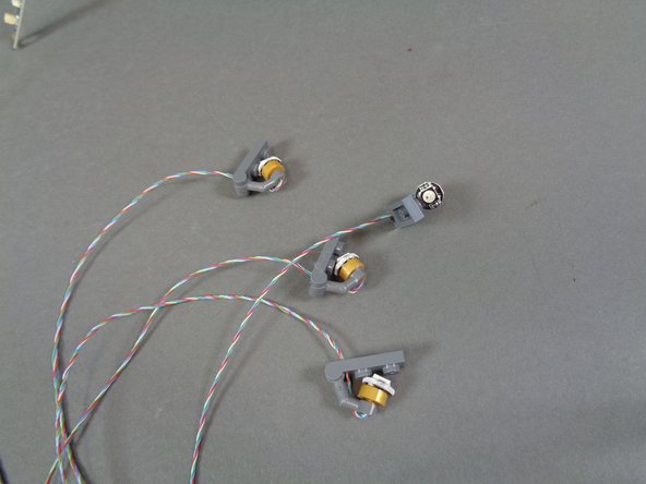 As shown in the second and third photos, remove four color-changing spotlights from the bag and mount them  along the castle base nest to the warm white spotlights (see the red arrows in the third photo).