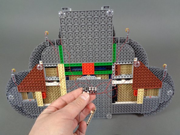 As shown in the photos for this step, connect the wires from the two front door torches to plugs 5 and 6 on the BRANCH09XS adapter board.