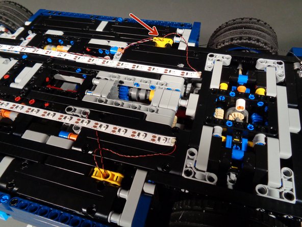 Feed the wires down into the main body of the Bugatti.  You will connect them later.