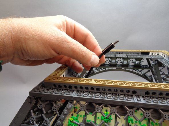 As shown in the first photo for this step, you will now have the power supply cable with barrel connector coming out of the base.