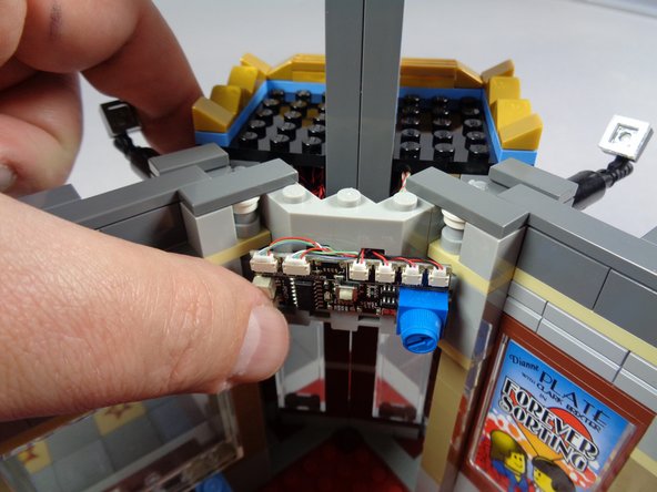 The third photo shows the controller mounted to the wall of the Palace Cinema above the door.  You can use the large sticky squares included with your light kit to attach the controller to an internal wall.