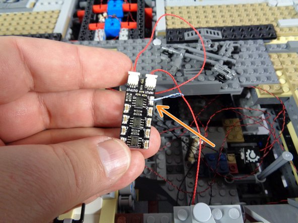 As shown by the orange arrow in the second photo, connect the small plug of the mandible lights to plug #1 on the second BRANCH09X adapter board.