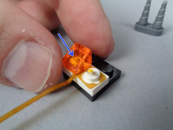 The flame assembly is designed to be able to flex and bend underneath LEGO parts without breaking.