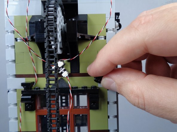 As shown in the photos for this step, begin routing the light strip wire using the same approach you used for the magnetic switch wire, except on the right side of the window frames this time.