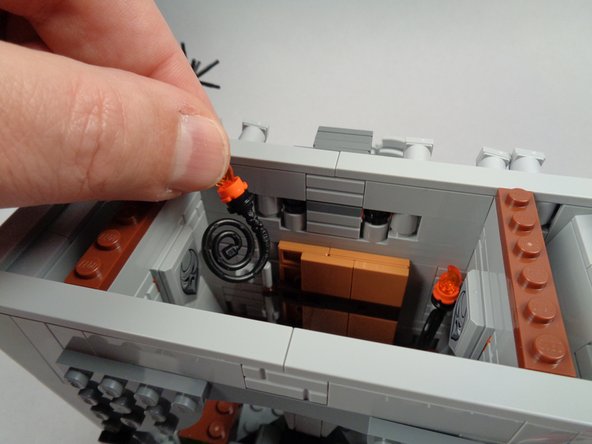 As shown in the first two photos for this step, remove the two torches from inside the town hall.