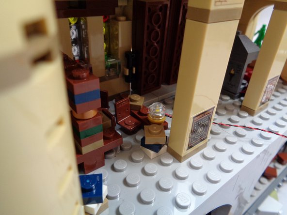 Use your fingernail to bend the light wire down the side of the stud, to make it easier to snap the clear piece on top.