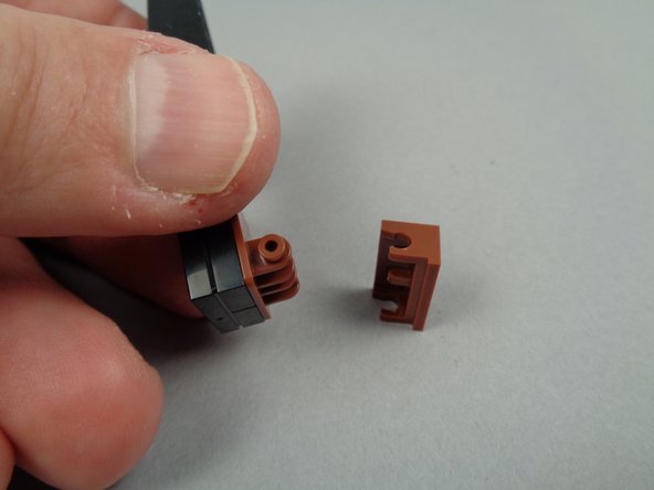 As shown in the second photo for this step, remove the 1x1 black slope part to make more room for wires.  The red arrow in the photo shows the location from which to remove the slope part.