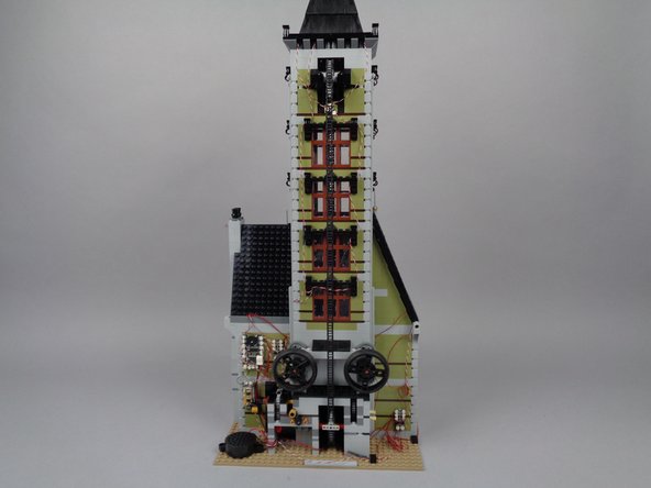 Take a moment to do one final check of the wires in the back of the mansion.  Make sure all wires are secured away from where they could get caught, pulled, or torn by any moving gears or parts.