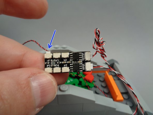 As shown by the arrow in the second photo for this step, connect the wire for the left torch to plug #4 on the BRANCH06X driver board.