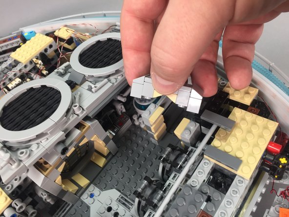 As shown in the photos in this step, remove the top of the rear door frame, attach another LED light to the top rear of the door frame using another small sticky square, then re-attach the door frame.