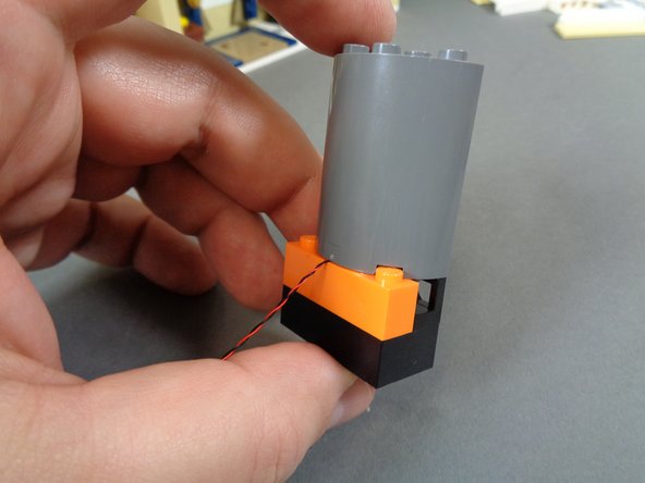 As shown in the second photo, re-attach the stove top and bottom.  The stove light wire should extend out the back.