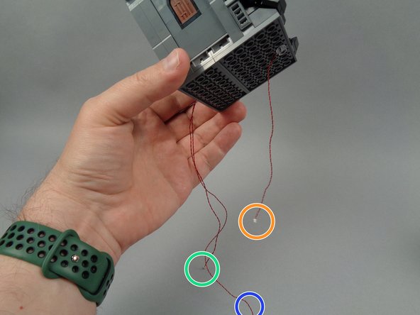 The third photo for this step shows the light wires you should now have hanging from the bottom of the second floor: