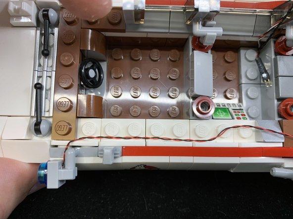 Remove the searchlight from the car, and replace with the pre-lit searchlight included with this kit.