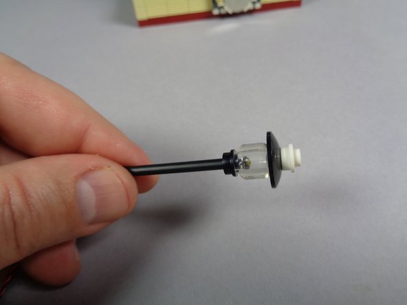 As shown in the third photo, re-attach the lamp post's top section.