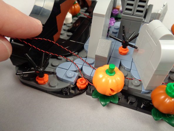 As shown in the second photo for this step, route both LED light wires toward the back.