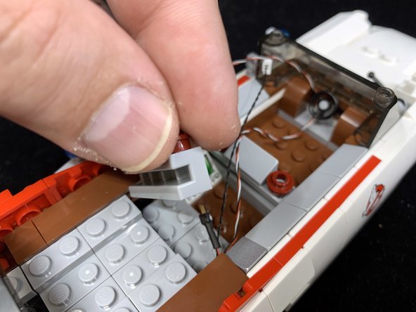 As shown in the first photo, re-attach the part you removed in Step 6.