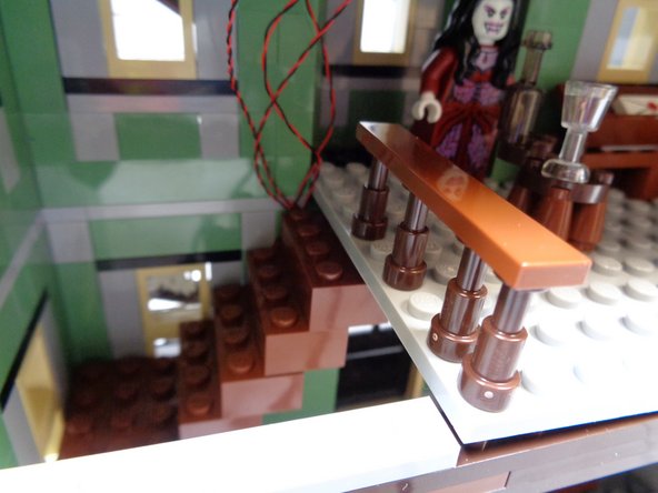 You will need to lift the center floor section a little bit to place the last 2x4 staircase brick.  Lift the floor section, replace the brick, and press the floor section back into place.