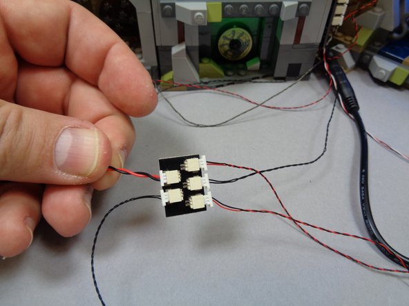 As shown in the second photo, connect the power wires from Hagrid's Hut and the Whomping Willow to the two small plugs on the BRANCH03 adapter.