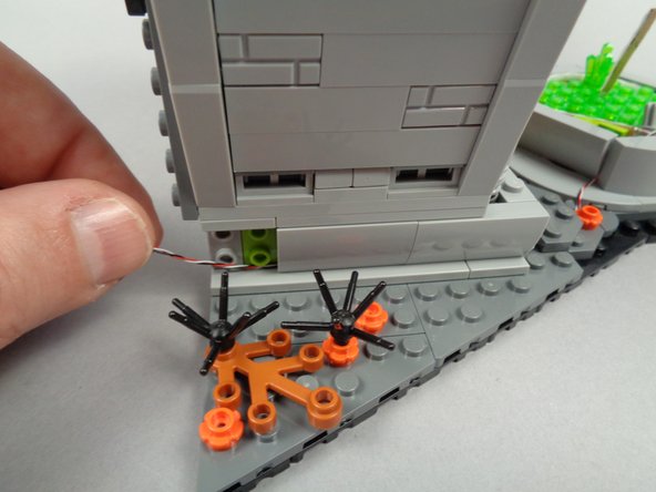 As shown in the third photo for this step, re-attach the middle slope side part to the town hall.