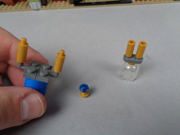 As shown in the photos for this step, remove the jewel case from the left side of the attic, and remove the top section along with the jewel and gold plate base.