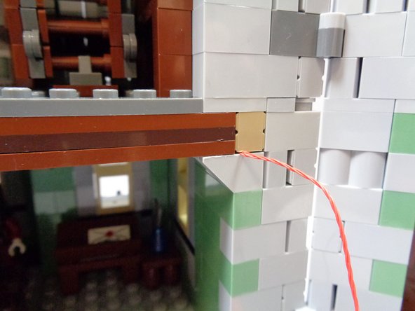 As shown in the second photo, make sure the red wire passes along the side of the drop-down attic stairs, so the stairs can still be lowered without hitting the red wire.