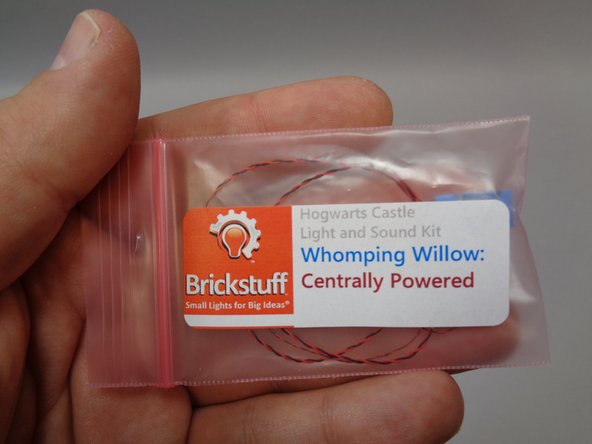 Take the pre-lit car assembly out of the &quot;Whomping Willow-- Centrally Powered&quot; bag, and as shown in the second photo, remove the white top and black wheels from the car in your LEGO® set and transfer them to the pre-lit car as shown in the third photo.