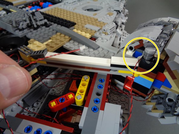 As shown by the yellow circle in the first photo, the cockpit light wire should pass out the back of the top corridor section.