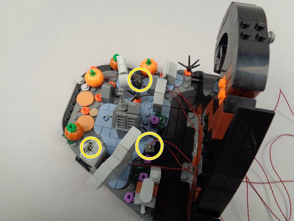 The yellow circles in the photos for this step show the positions for the three yellow LED lights.