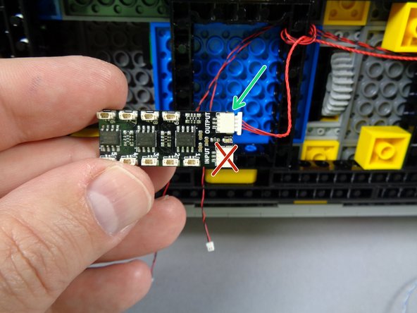 Take the second and final BRANCH09X adapter board from the &quot;MAIN CHASSIS PARTS&quot; bag, and connect the red control cable to the &quot;OUTPUT&quot; plug on the BRANCH09X adapter.