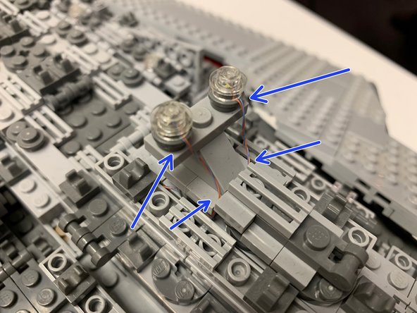 Bag 5 includes two pairs of cool white LEDs.  You will use one of these pairs to mount as marker lights on top of the ship.  Two transparent round 1x1 LEGO plates are also included in Bag 5.