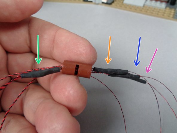 Carefully pull the wires through the LEGO connector, one by one.