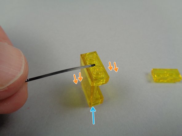 As shown by the orange arrows in the second photo for this step, mount the flexible LED light with its light element facing DOWN.  Make sure to position the light element so it is centered on top of the window, with the black strip between the two studs.