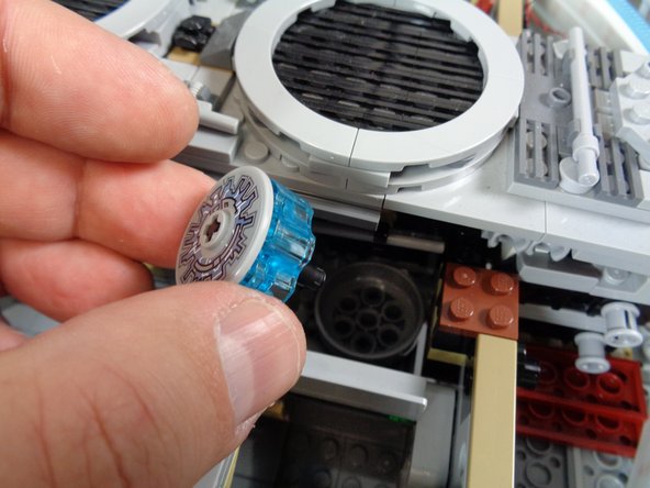 As shown in the first photo, remove the center portion of the hyperdrive in the back of the Falcon.