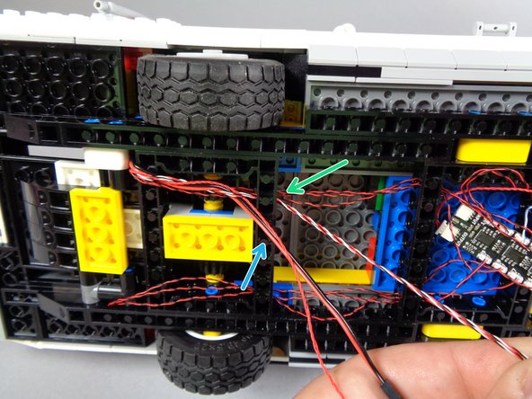 The first photo for this step shows the four wires you should now have passing through to the bottom of the vehicle frame.