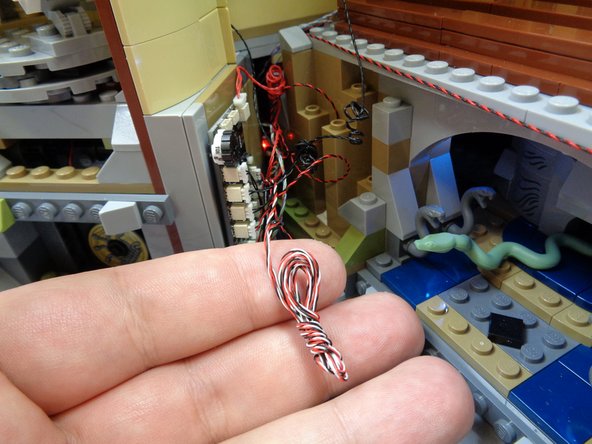 The photos in this step show some additional ways you can coil wires and hide adapter boards so the visible wires in the rear of the castle are kept to a minimum.