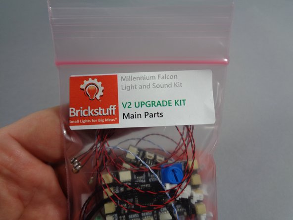 As shown in the photos for this step, open your upgrade kit and remove the pink bag with the label &quot;Main Parts.&quot;