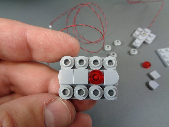 The mandibles bag also includes two round clear LEGO tiles.  You can use these instead of the transparent red tiles that came with your original kit to model different versions of the Falcon.