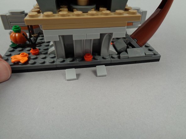 As shown in the first photo for this step, remove the two 1x1 slopes from underneath the rock arches from Jack's House.