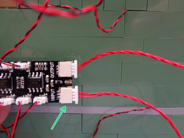 Take the second red 3-wire control wire from Bag 1 and connect one end to the large INPUT plug on the BRANCH09X adapter board as shown by the green arrow in the first photo.